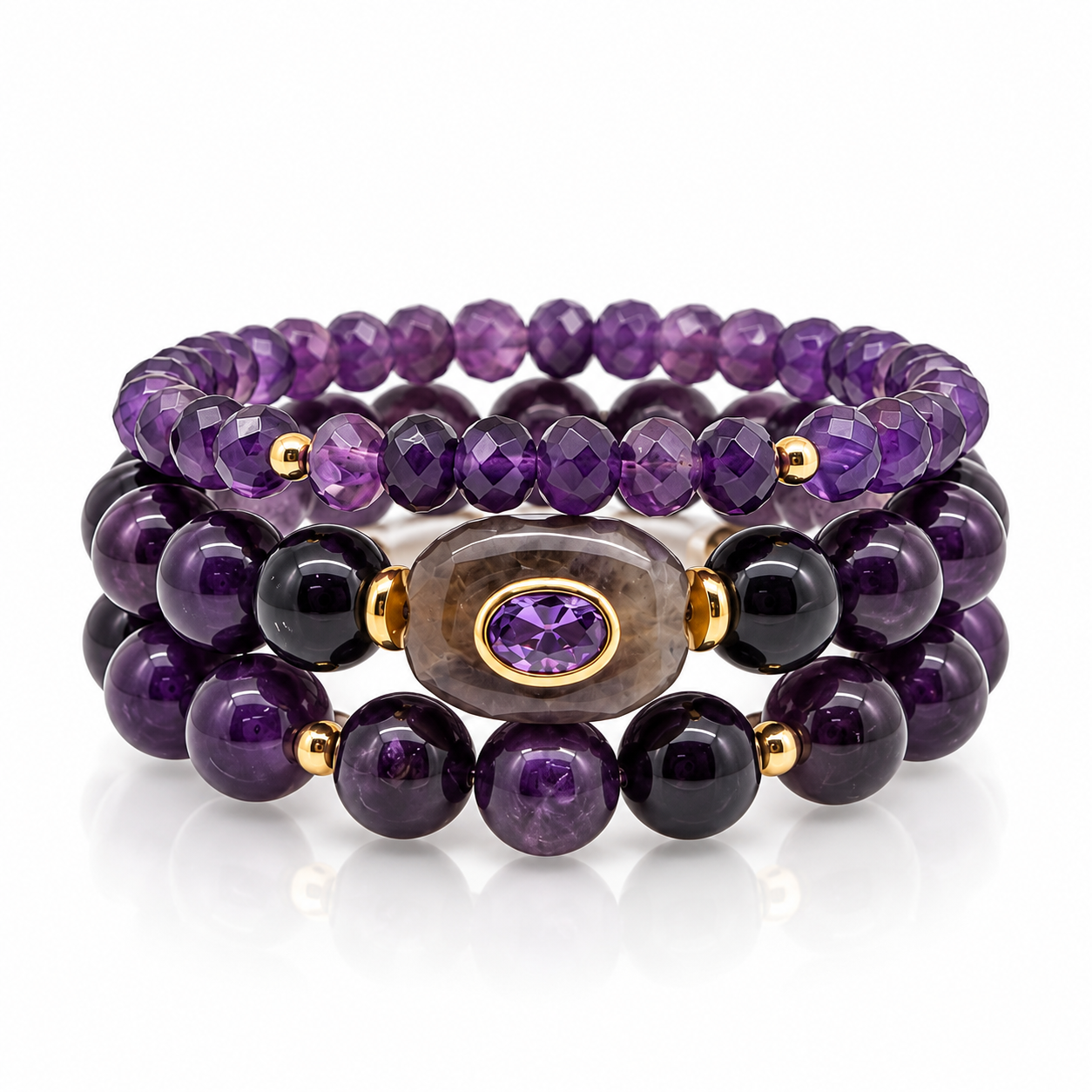 Three-piece Amethyst Stack bracelet set with smooth and faceted purple beads, gold-tone accents, and an oval centerpiece on a white background.


